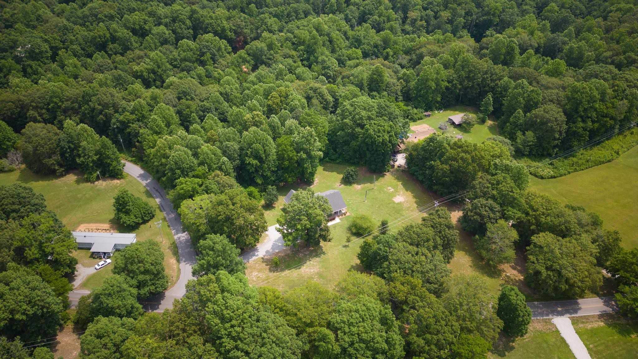 16 Shasteen Ridge Road Lynchburg, TN 37352 - Photo 41 of 55 an aerial view of residential houses with outdoor space and trees all around