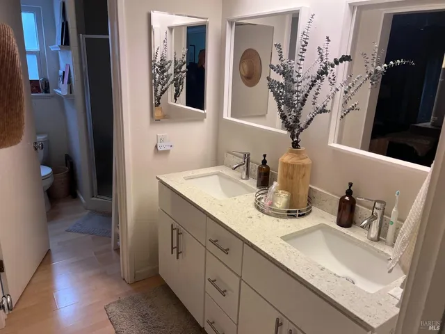 a bathroom with a double vanity sink and a mirror