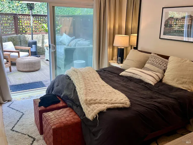 a bedroom with a bed and glass window