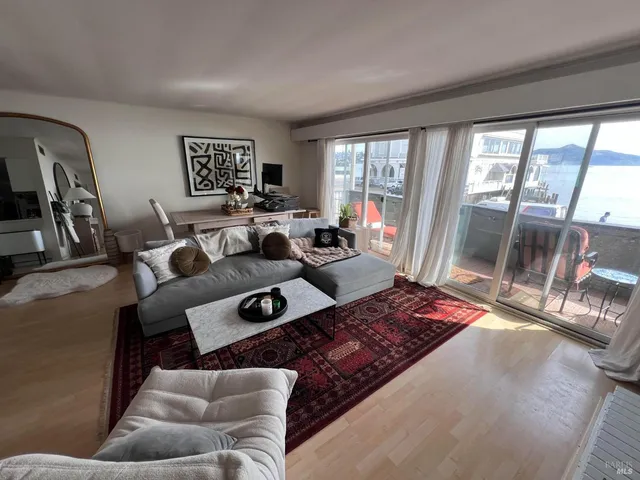 a living room with furniture and a floor to ceiling window