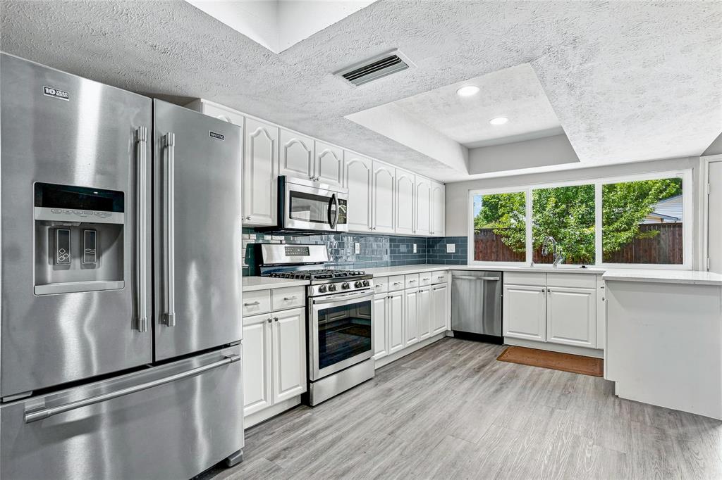 6203 Rainier Road Plano, TX 75023 - Photo 1 of 35 Kitchen with Quartz Counters