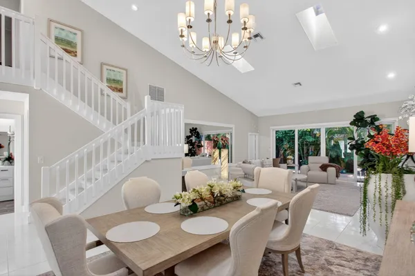 a view of a dining room with furniture a chandelier and wooden floor