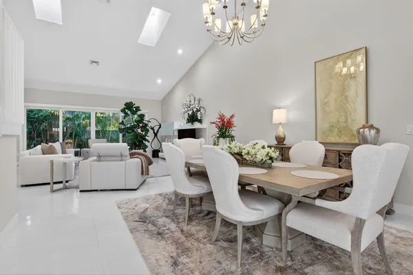 a living room with furniture and a large mirror
