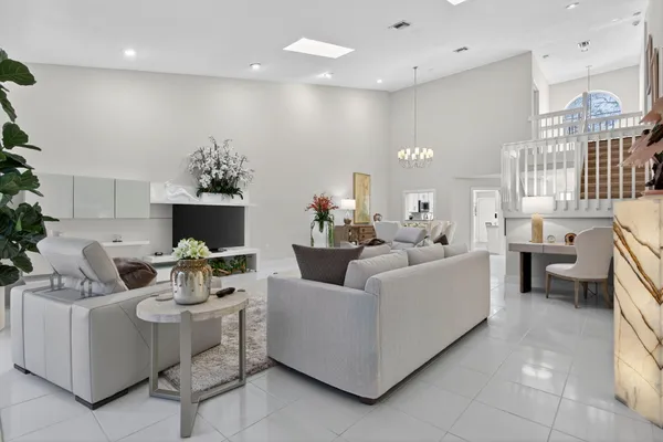 a living room with furniture a table and chairs