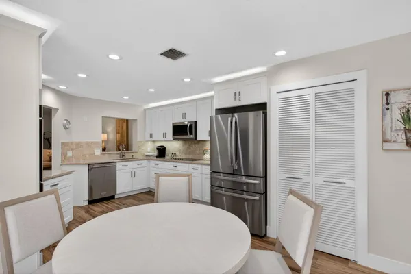 a kitchen with stainless steel appliances a refrigerator stove microwave and cabinets