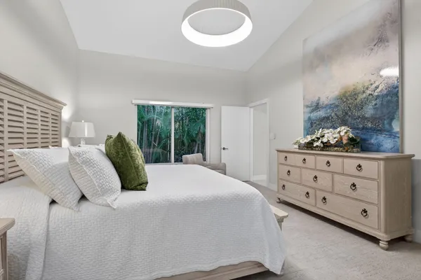 a bathroom with a shower sink vanity mirror and toilet