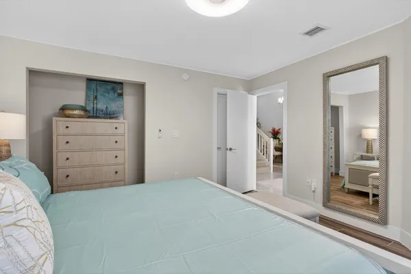 a spacious bedroom with a bed and a couch