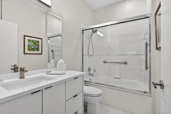 a view of a backyard with plants and large trees