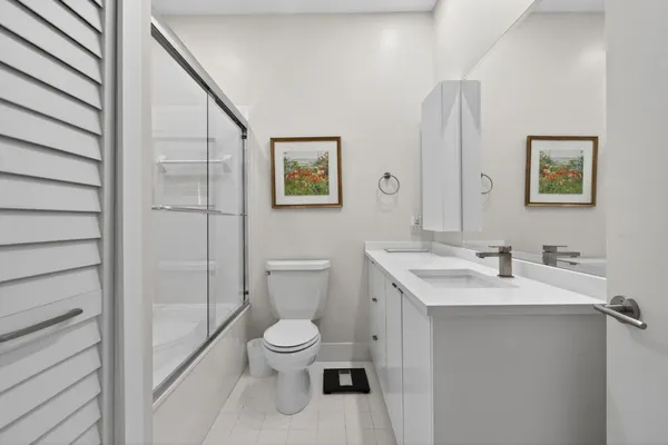 an aerial view of residential houses with outdoor space and trees all around