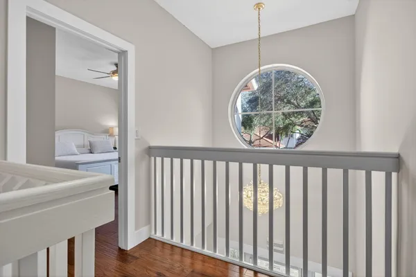 an aerial view of residential houses with outdoor space and trees