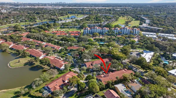 a backyard view of a house with porch and outdoor seating