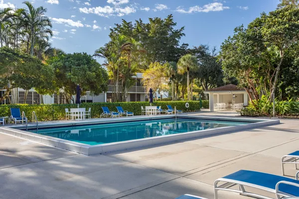 a view of a chairs and tables in the patio and a fountain