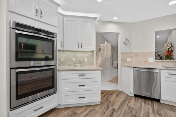 a view of a dining room with furniture a chandelier and wooden floor