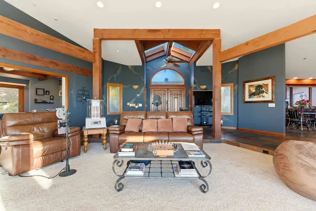 a living room with lots of furniture and a large window