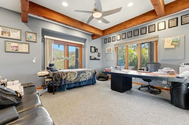 a living room with furniture and floor to ceiling windows