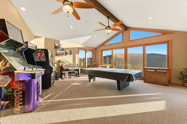 a living room with furniture and a ceiling fan