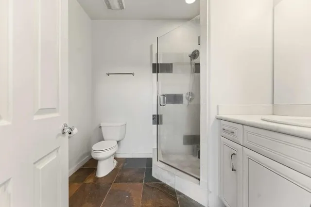 a bedroom with a bed and large mirror