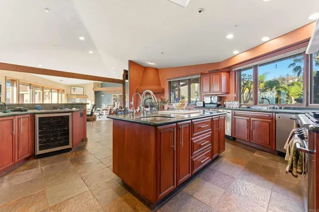 a kitchen with stainless steel appliances granite countertop a sink and a stove