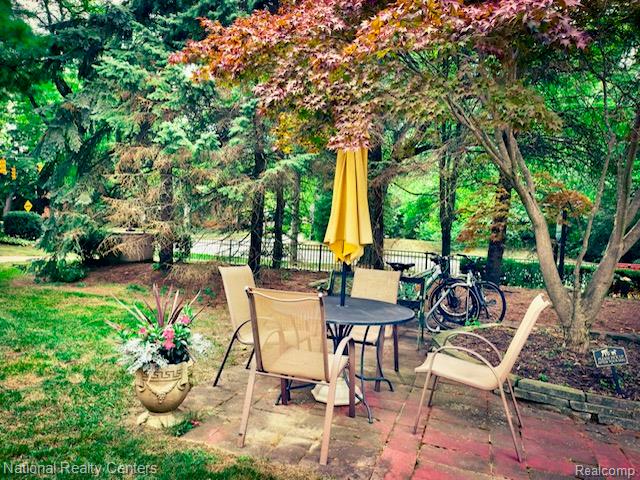 475 South Adams Road, Unit 19 Birmingham, MI 48009 - Photo 3 of 20 Brick paver patio surrounded by mature trees and landscaping