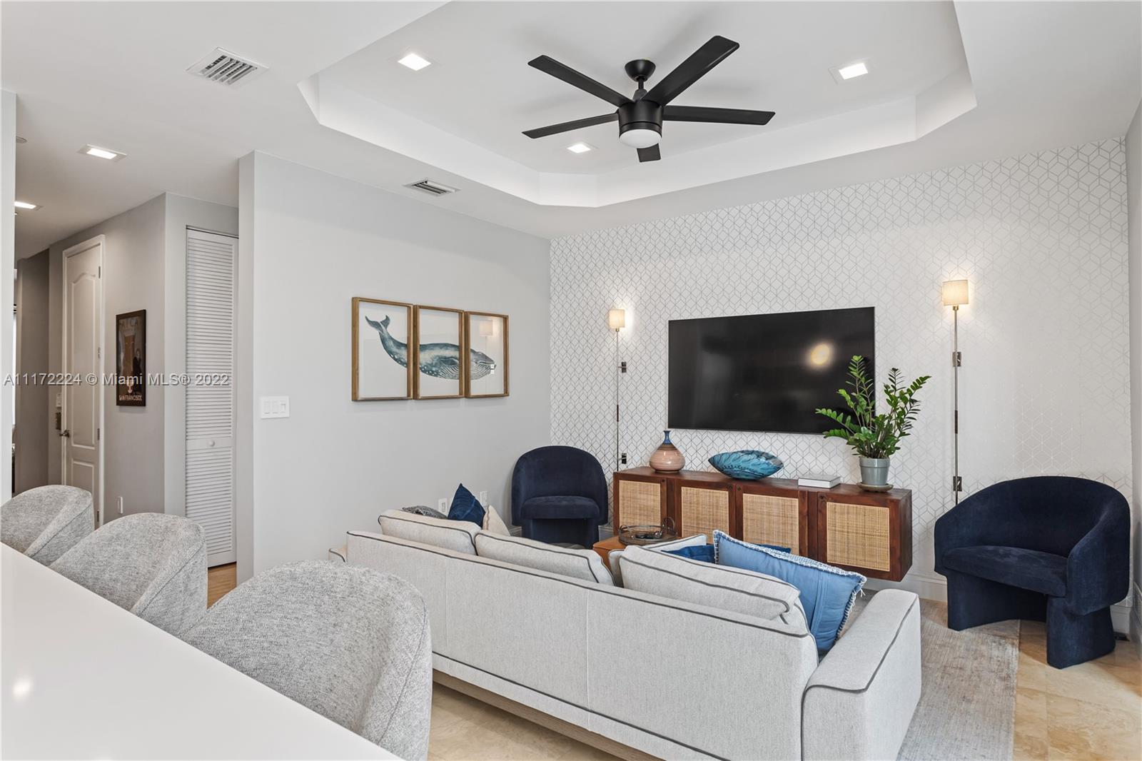 7682 Southwest 54th Avenue Miami, FL 33143 - Photo 12 of 37 a living room with furniture and a flat screen tv
