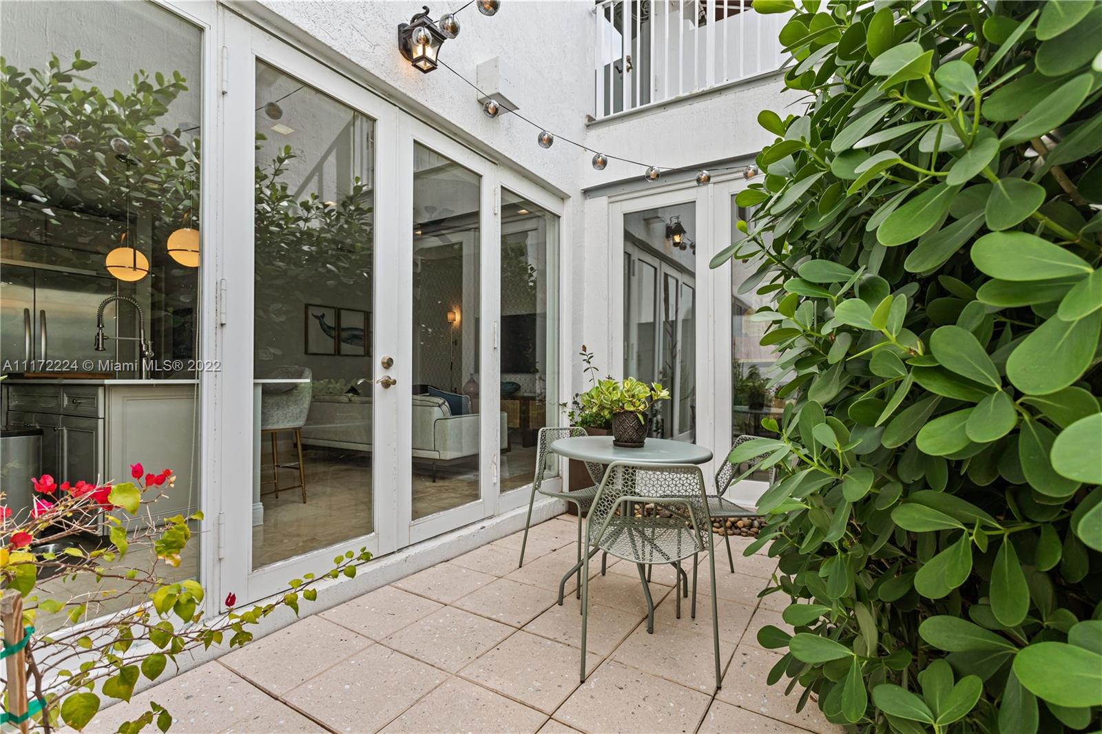 7682 Southwest 54th Avenue Miami, FL 33143 - Photo 14 of 37 a patio with table and chairs and potted plants