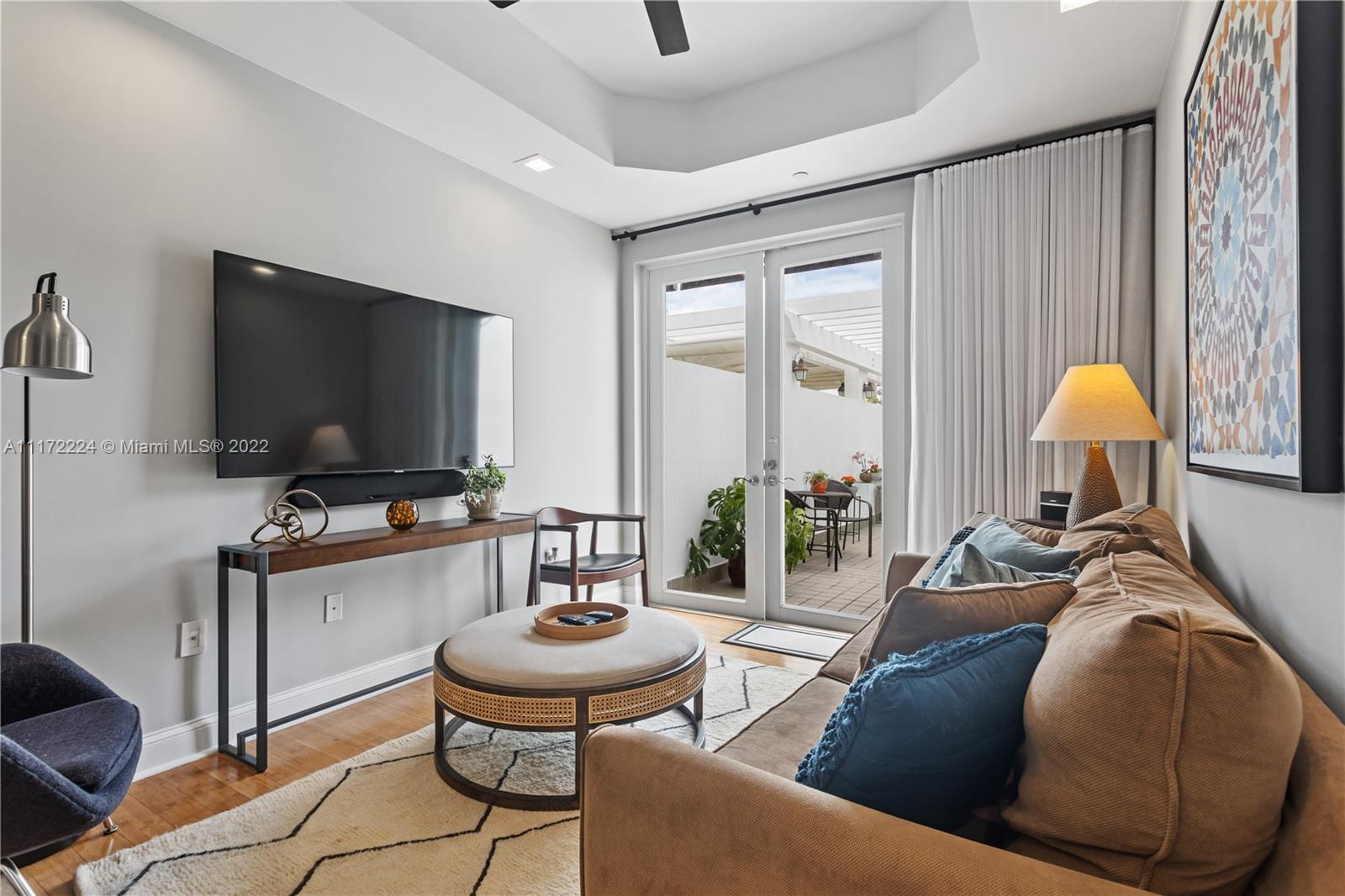7682 Southwest 54th Avenue Miami, FL 33143 - Photo 20 of 37 a living room with furniture and a flat screen tv