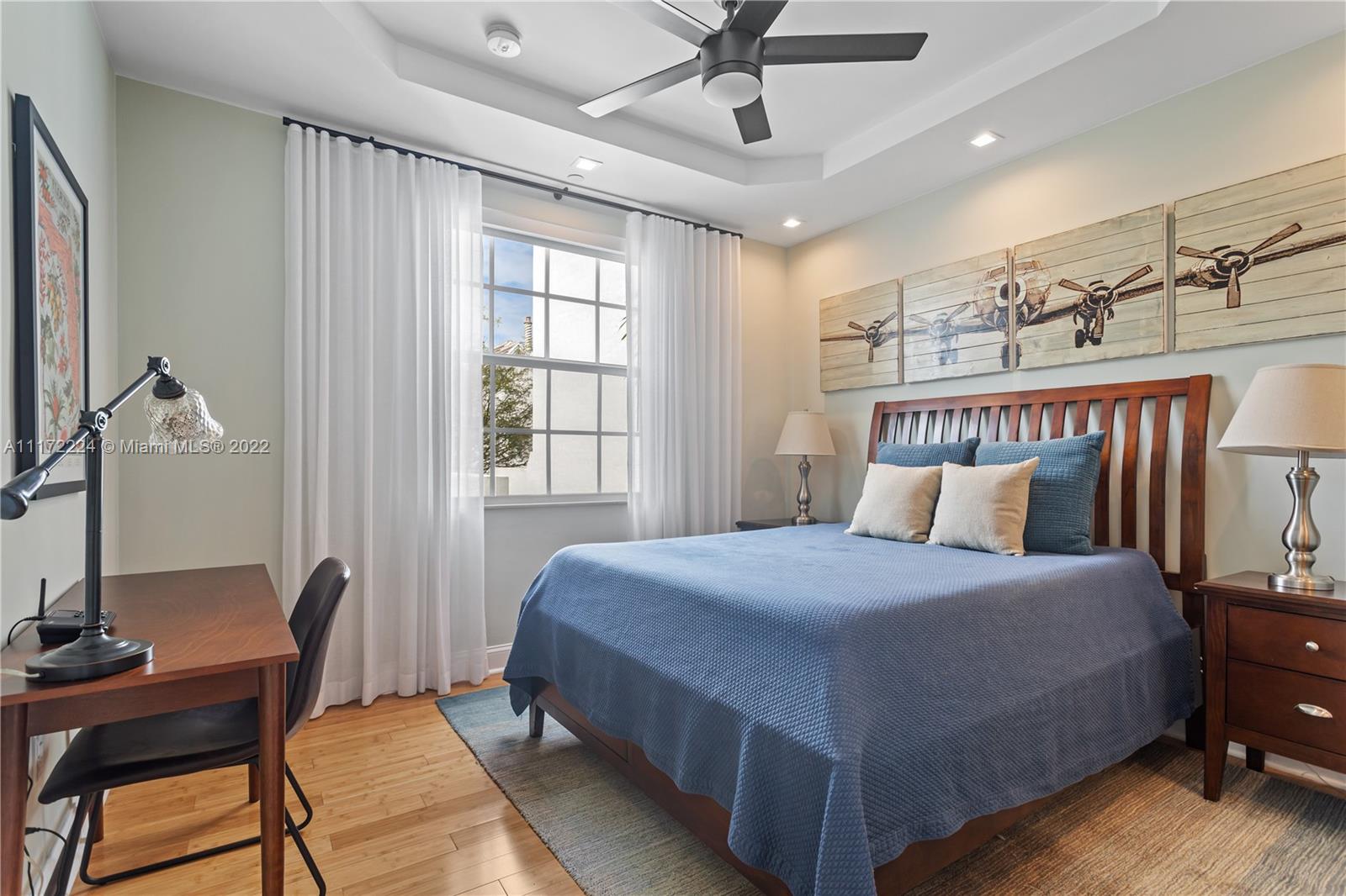 7682 Southwest 54th Avenue Miami, FL 33143 - Photo 21 of 37 a bedroom with a bed a chair and potted plant on the dresser