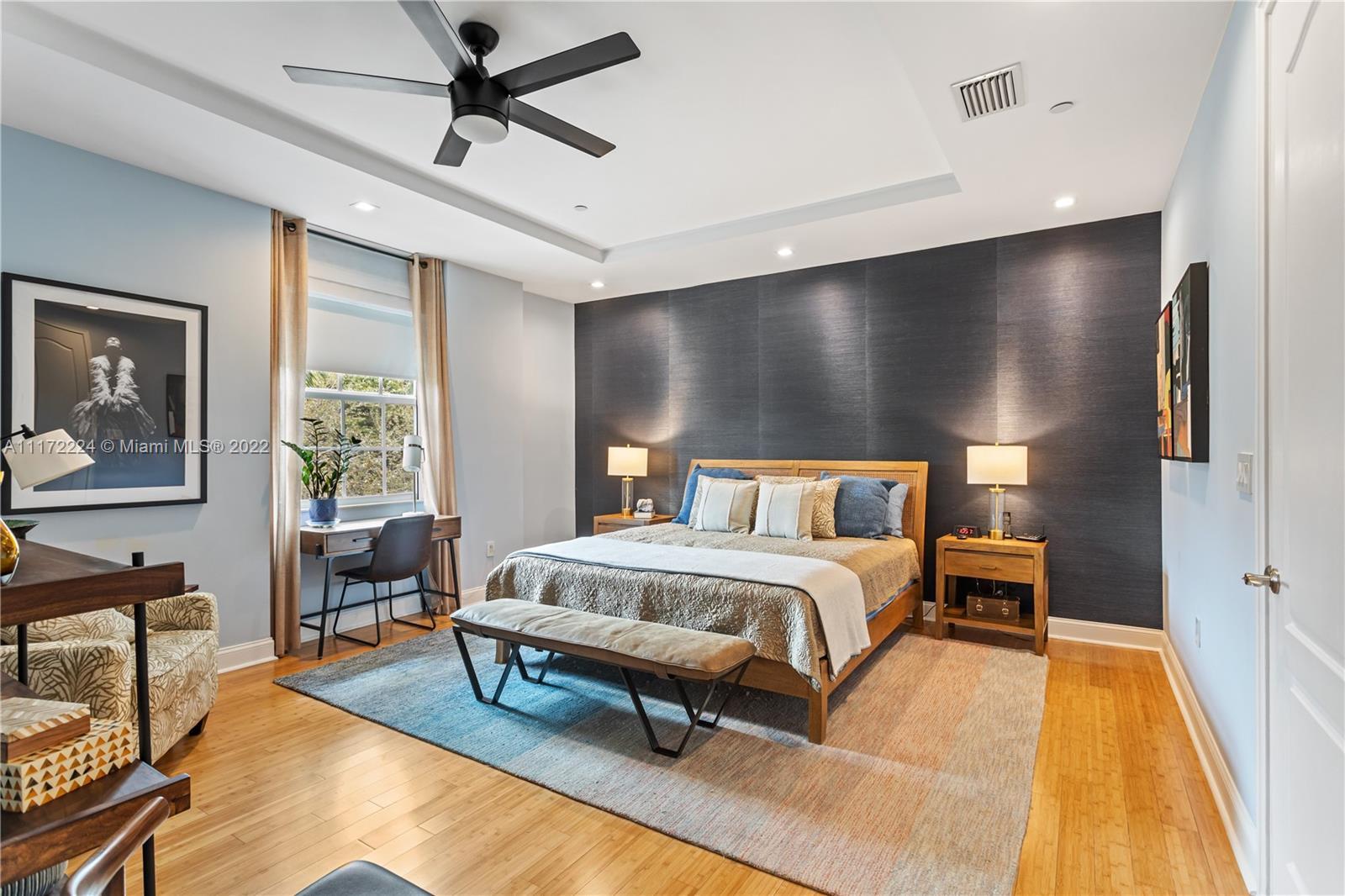 7682 Southwest 54th Avenue Miami, FL 33143 - Photo 23 of 37 a spacious bedroom with a bed and table chair