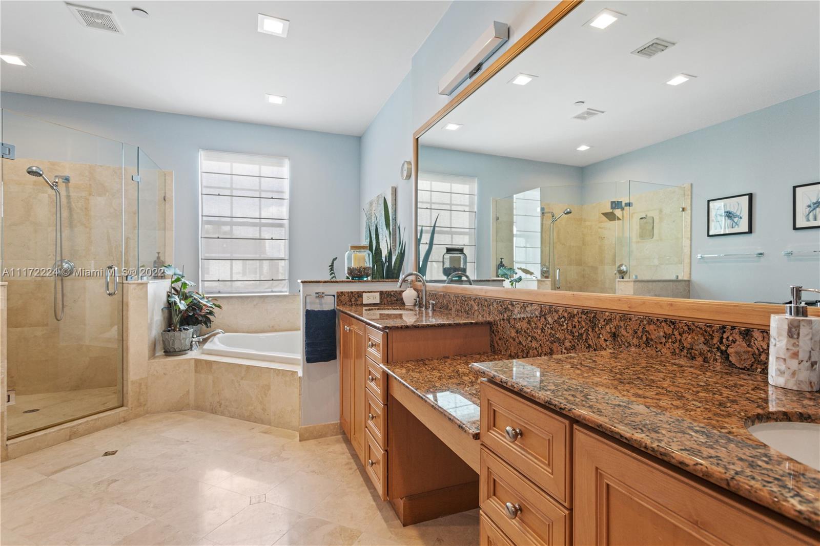 7682 Southwest 54th Avenue Miami, FL 33143 - Photo 24 of 37 a spacious bathroom with a tub a mirror and a shower