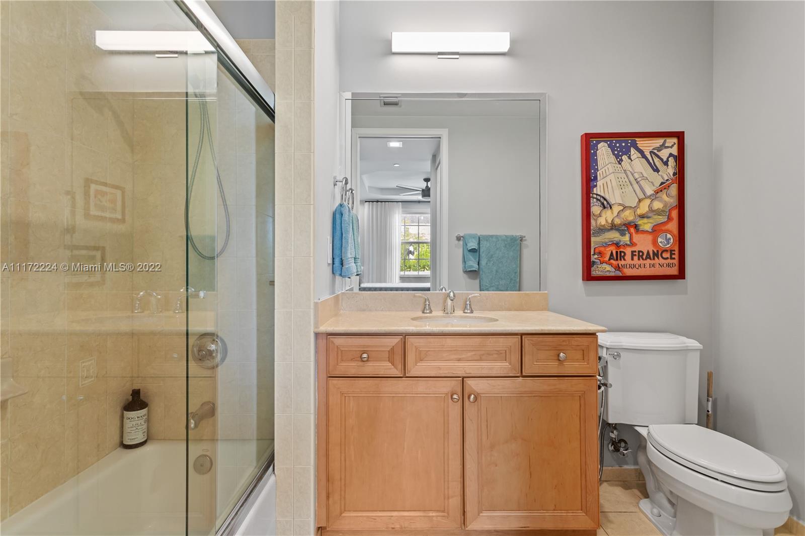 7682 Southwest 54th Avenue Miami, FL 33143 - Photo 27 of 37 a bathroom with a granite countertop toilet sink and shower