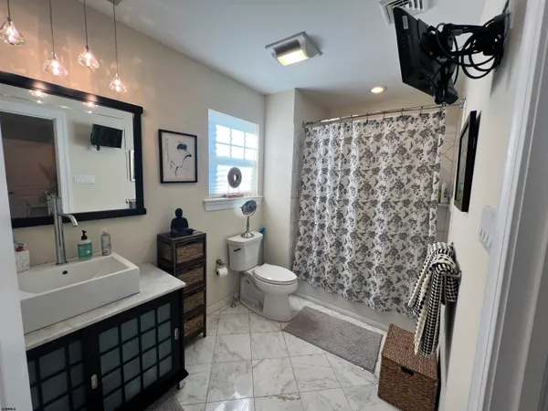 a bathroom with a sink toilet and shower