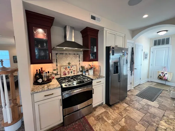 a kitchen with stainless steel appliances a stove and a refrigerator