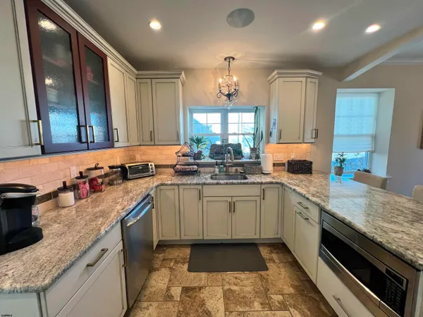 a kitchen with sink stove and cabinets