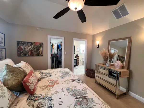 a bedroom with a bed and a mirror