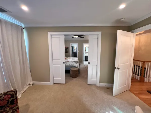 a view of a livingroom with furniture and a hallway
