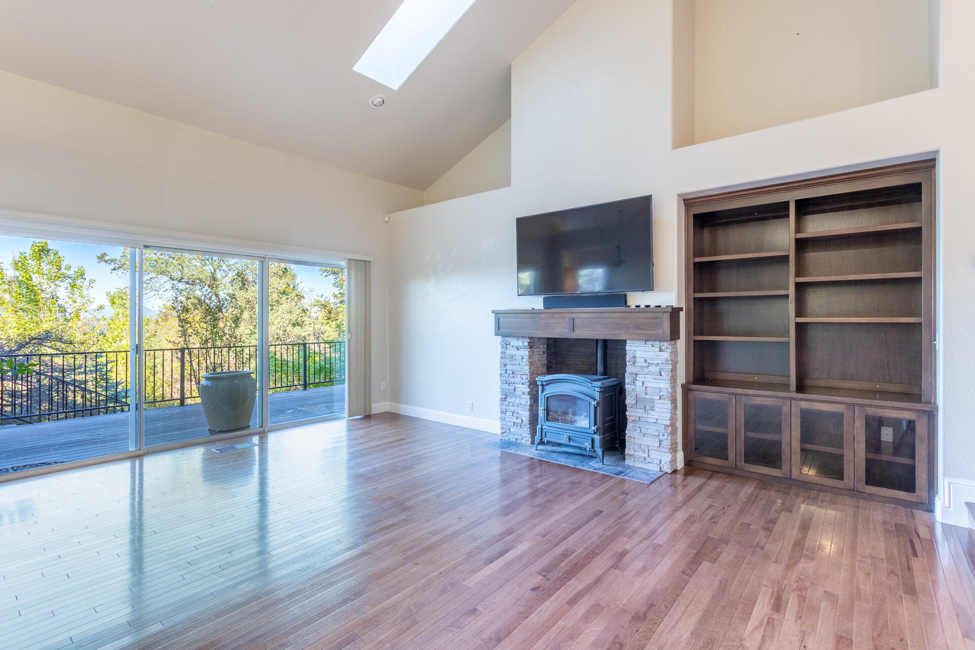 3126 Riesling Path Redding, CA 96001 - Photo 4 of 32 a view of empty room with wooden floor and fireplace