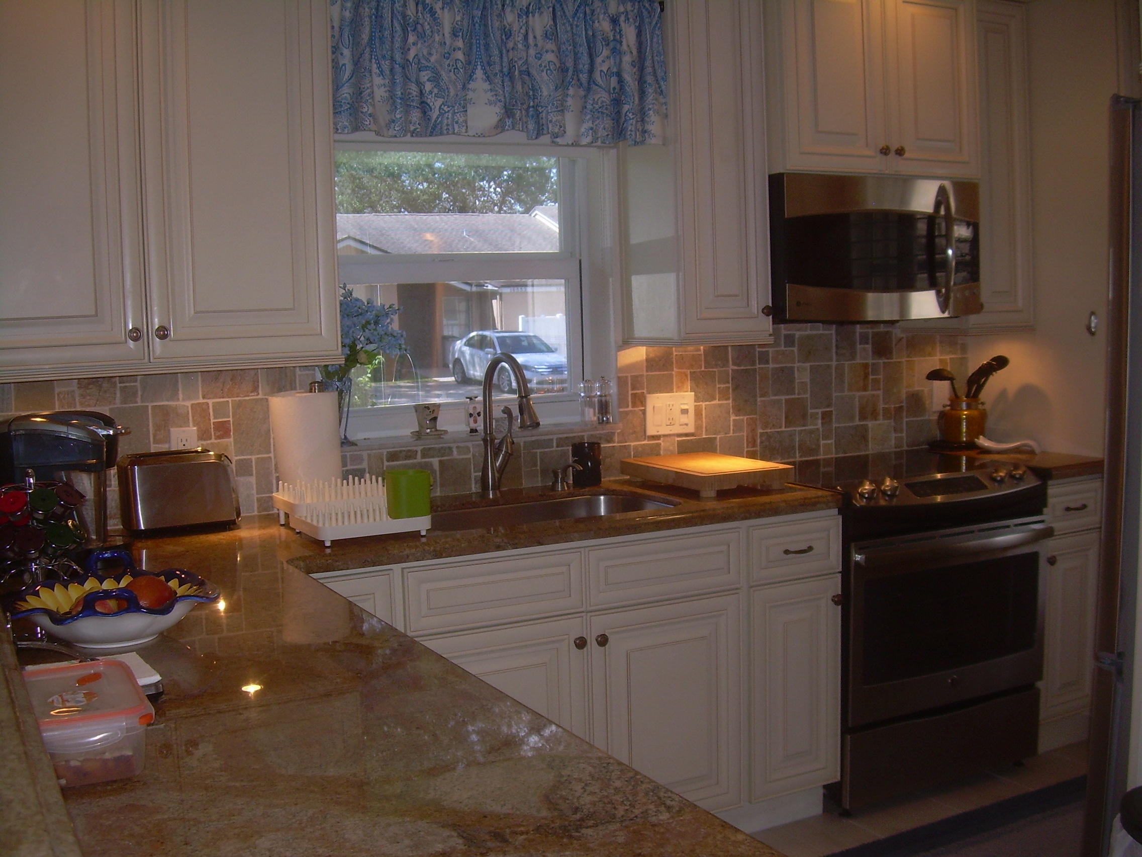 8700 Jasmine Way, Unit B Boca Raton, FL 33496 - Photo 10 of 32 a kitchen with sink a microwave and cabinets