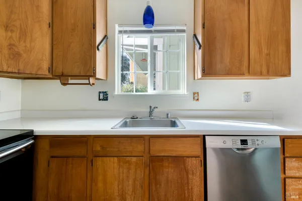 a kitchen with a sink cabinets and a window