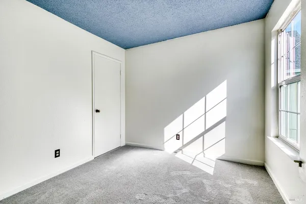 a view of an empty room and a window
