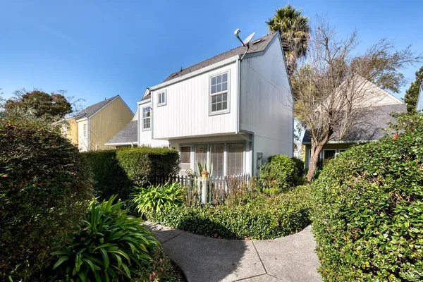 a front view of a house with a garden