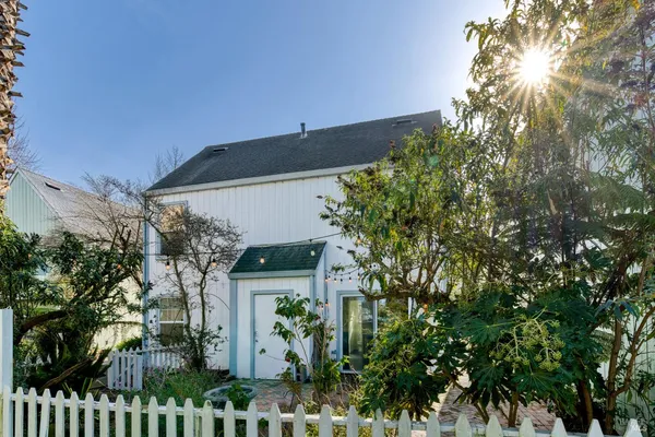 a view of a house with a tree
