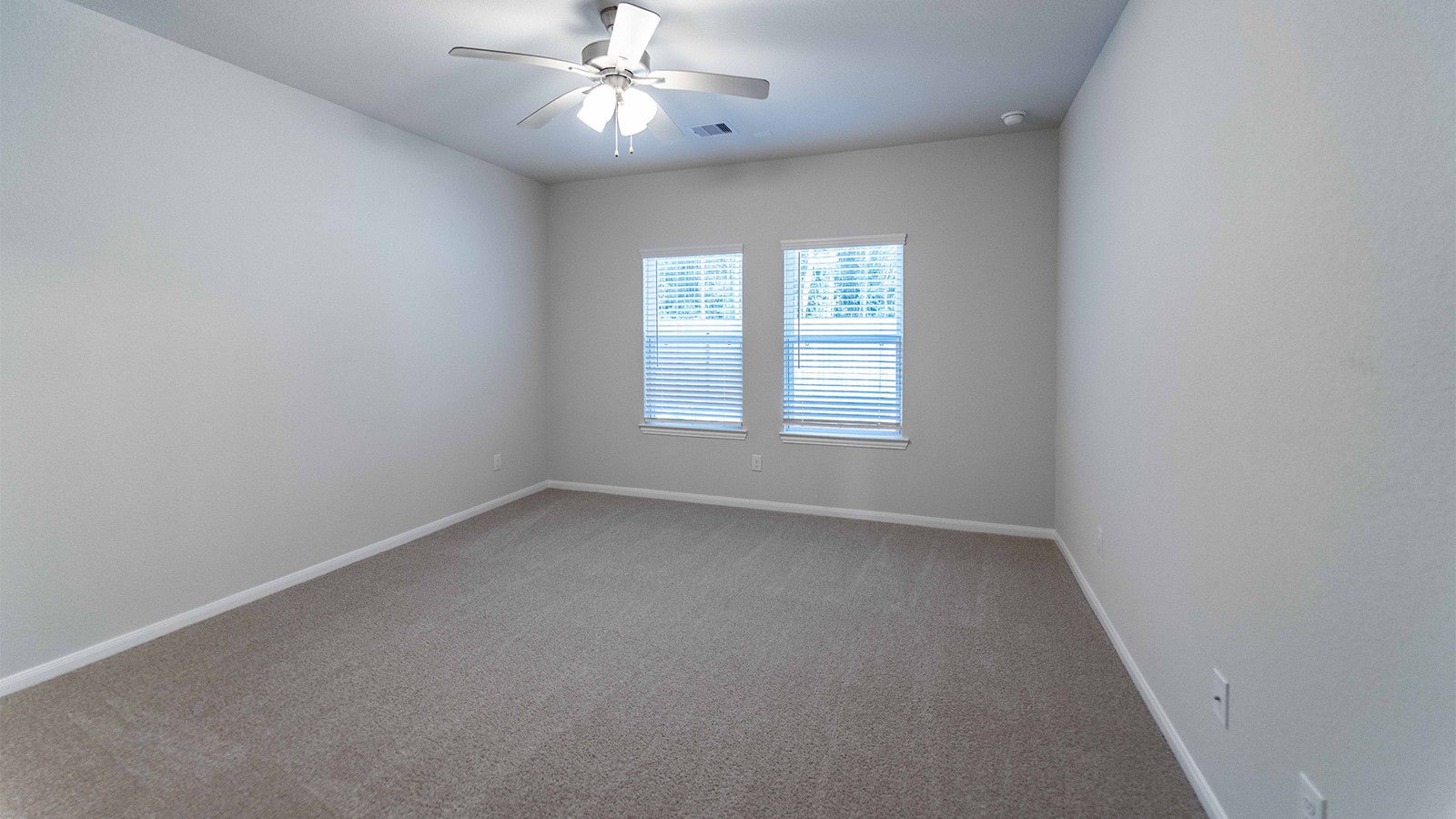 22003 Blue Sky Way New Caney, TX 77357 - Photo 6 of 15 an empty room with a window and a fan