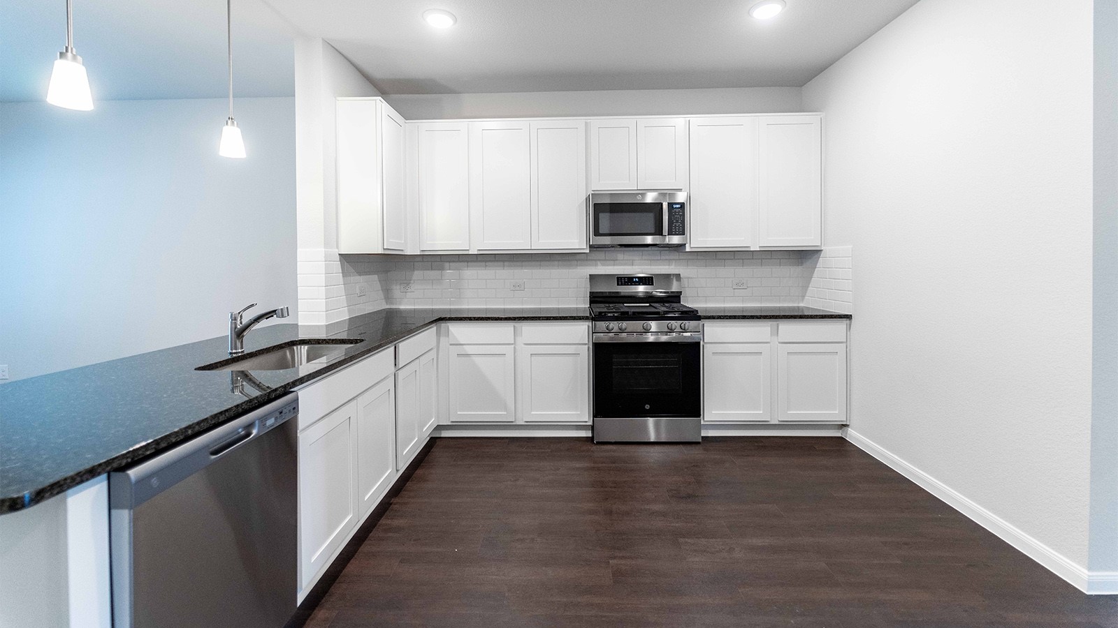 22003 Blue Sky Way New Caney, TX 77357 - Photo 9 of 15 a kitchen with stainless steel appliances a white stove top oven and sink