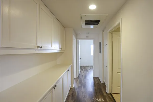 a view of a hallway with wooden floor