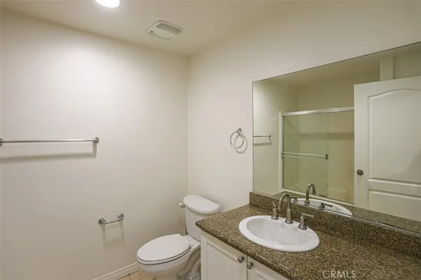 a bathroom with a sink toilet a mirror and vanity