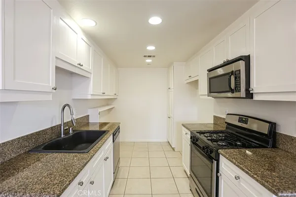 a kitchen that has a sink and a stove