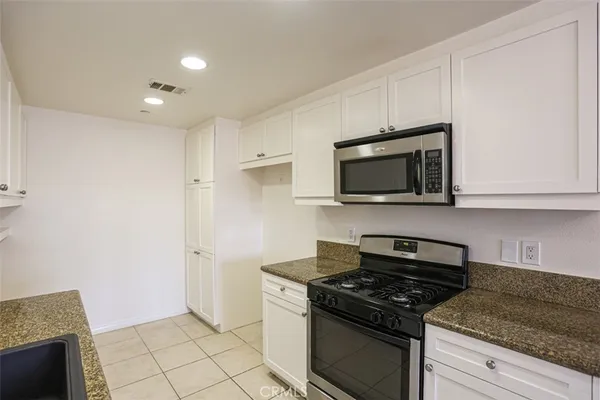 a kitchen with a stove and a microwave