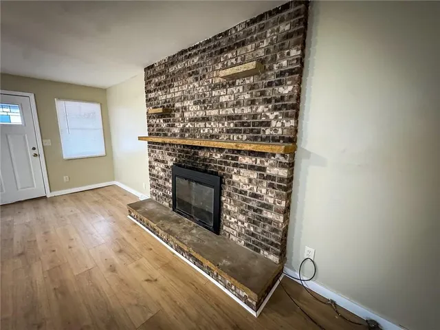 a large kitchen with cabinets wooden floor and stainless steel appliances