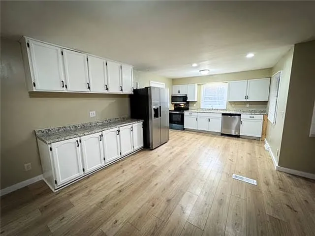 a kitchen with granite countertop a sink and a stove
