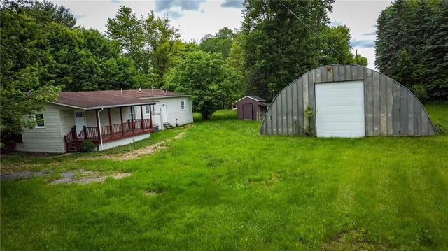 a view of a house with a yard and sitting area